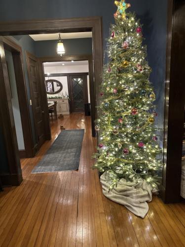 slim faux entryway tree with vintage ornaments and twinkle lights